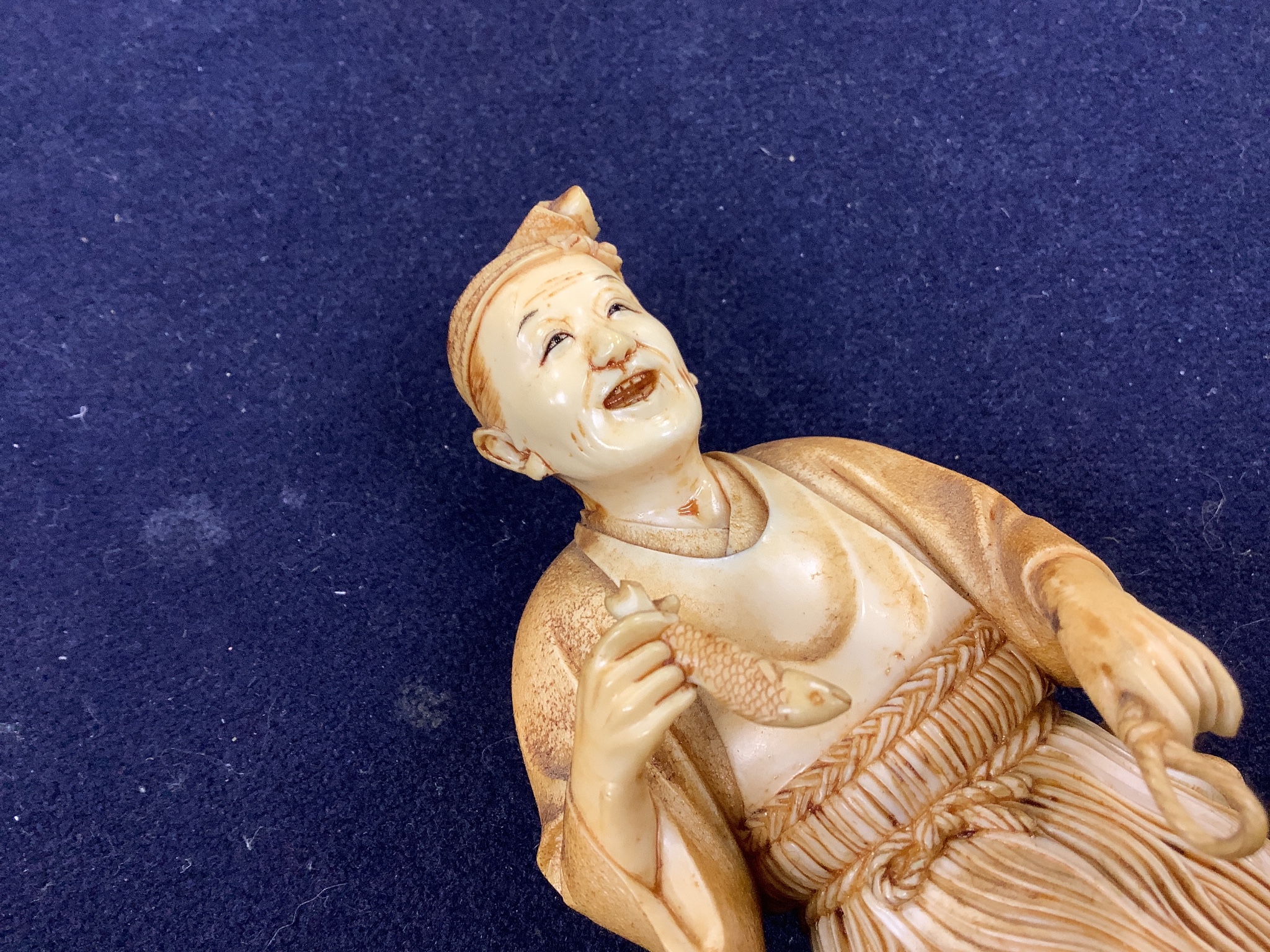 A Japanese ivory figure of a cormorant fisherman, early 20th century